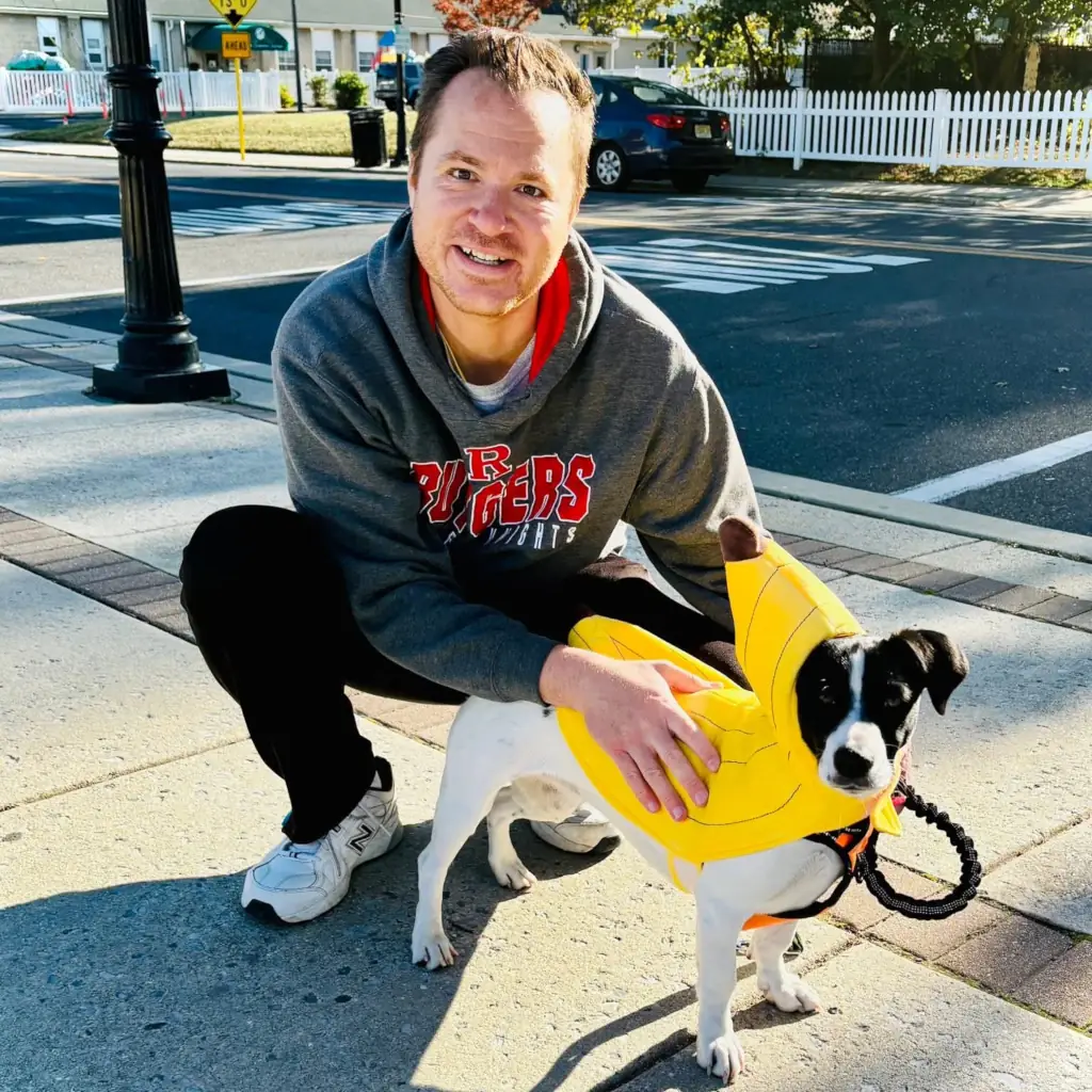 Jesse poses with his dog Sandy wearing a yellow banana costume at Halloween parade in Oaklyn, NJ.