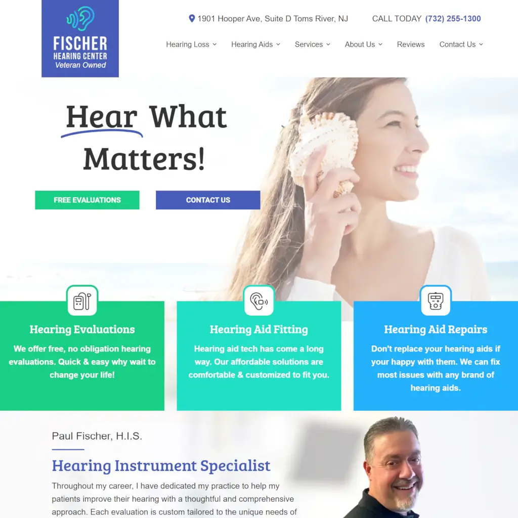 Fischer Hearing Center homepage hero banner featuring hearing loss solutions with call-to-action buttons and service cards.