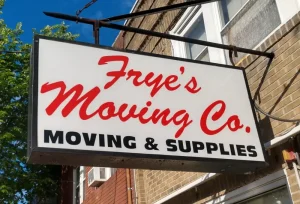 Frye's Moving Co storefront sign with red script and black text advertising moving and supplies services.